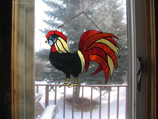 rooster struts across the window