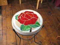 Rose stepping stone displayed in the rod iron table