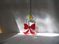 smallbevelled candle is highlited with a bright red bow